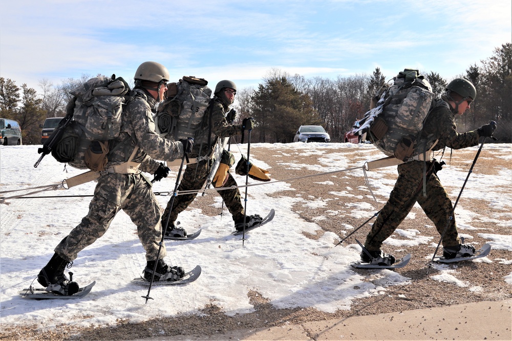 Cold-Weather Operations Course Class 20-03 students practice snowshoeing, ahkio sled use