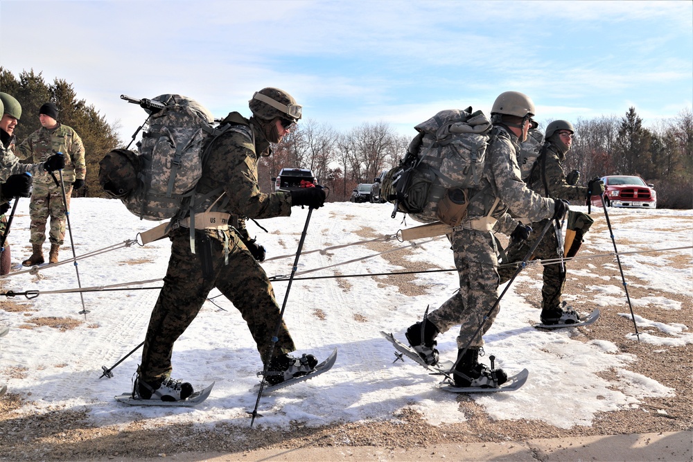 Cold-Weather Operations Course Class 20-03 students practice snowshoeing, ahkio sled use