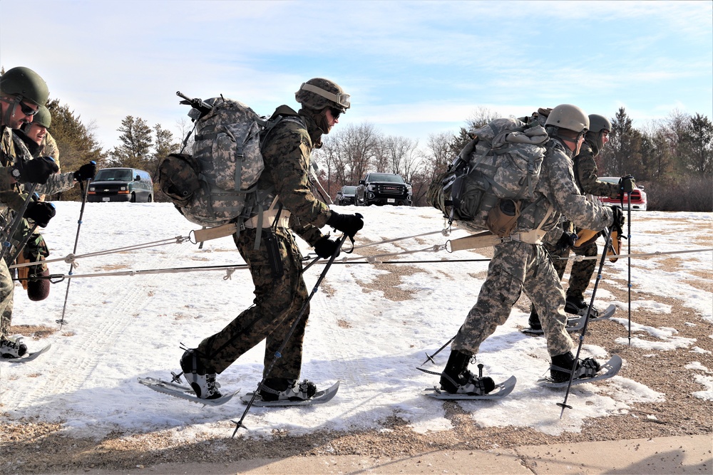 Cold-Weather Operations Course Class 20-03 students practice snowshoeing, ahkio sled use