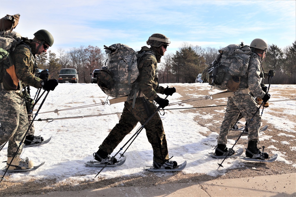 Cold-Weather Operations Course Class 20-03 students practice snowshoeing, ahkio sled use