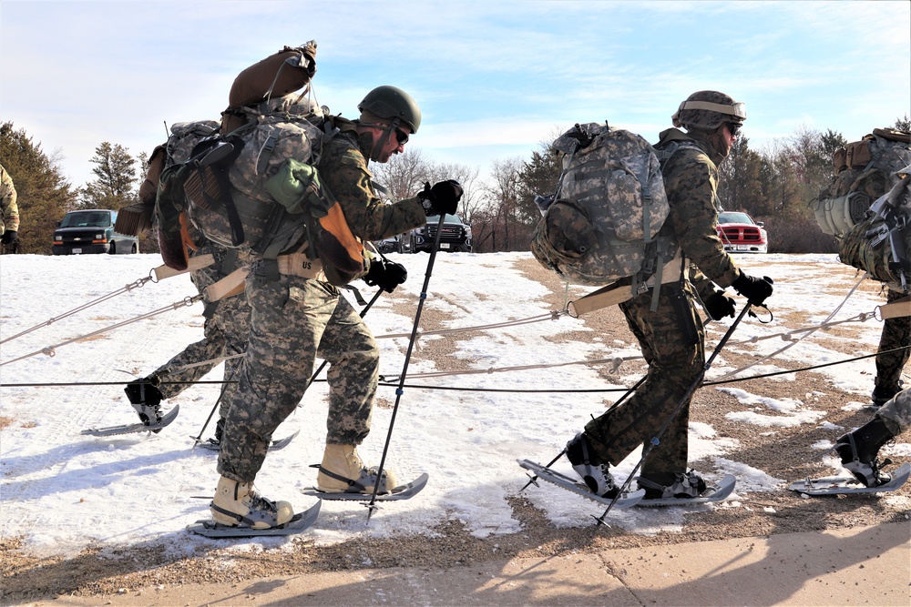 Cold-Weather Operations Course Class 20-03 students practice snowshoeing, ahkio sled use