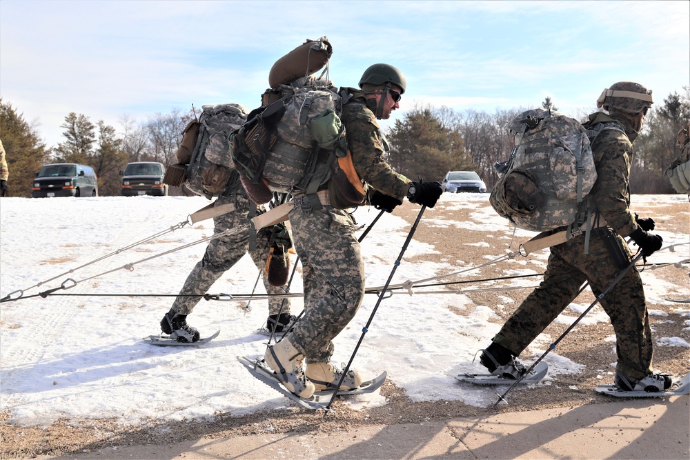 Cold-Weather Operations Course Class 20-03 students practice snowshoeing, ahkio sled use