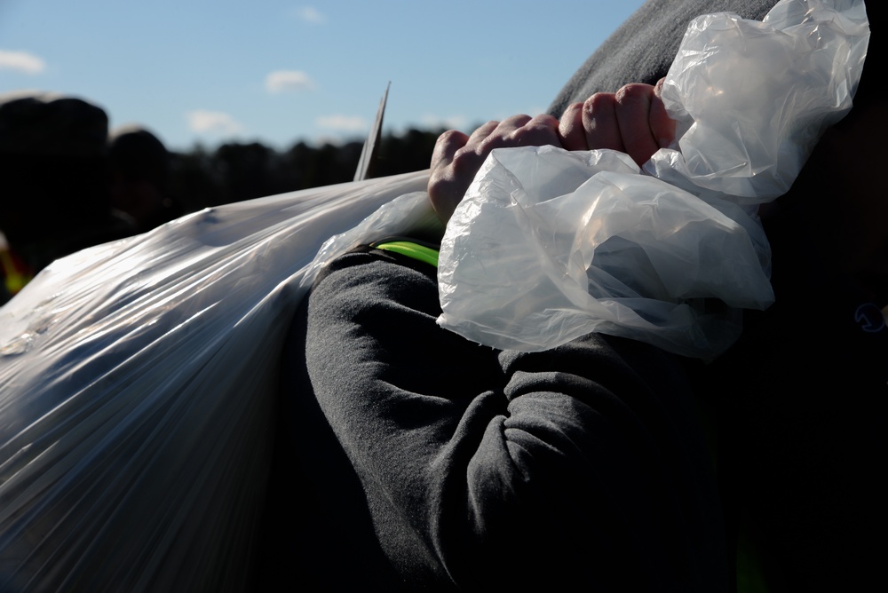 Members of the 177th Fighter Wing Student Flight clean up base perimeter