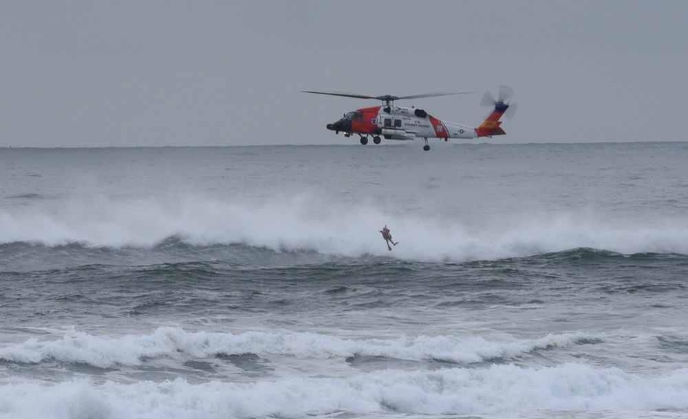 Coast Guard lowers rescue swimmer into surf