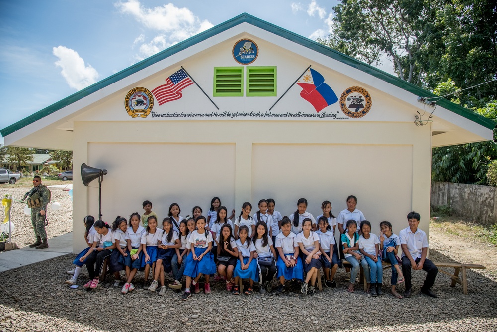 U.S. Navy Seabees with NMCB-5’s Detail Palawan attend the ribbon cutting ceremony at Malatgao Elementary School