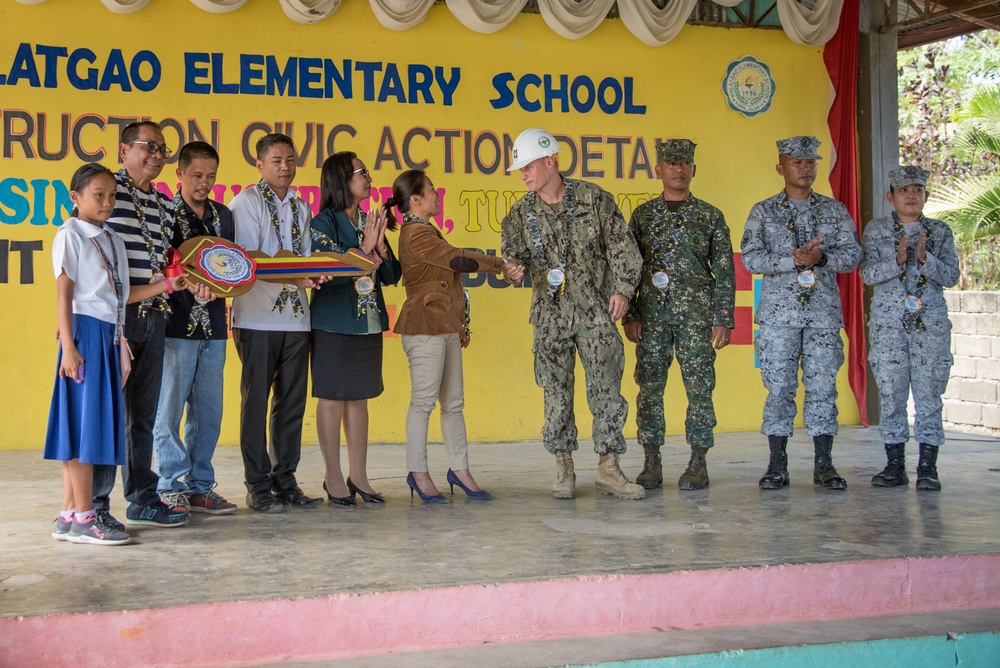 U.S. Navy Seabees with NMCB-5’s Detail Palawan attend the ribbon cutting ceremony at Malatgao Elementary School