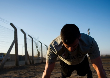 Soldier does physical training at Camp Taji