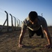 Soldier does physical training at Camp Taji