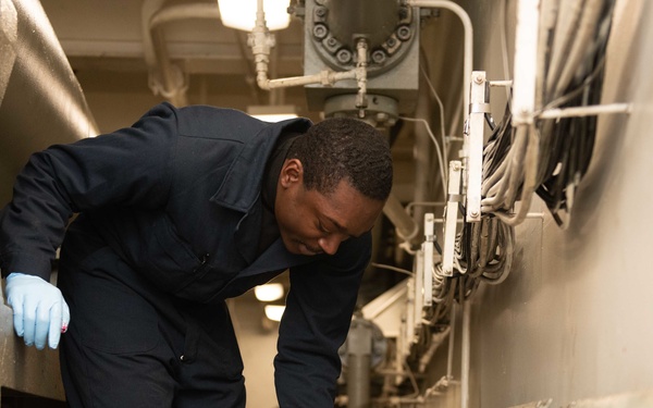 U.S. Navy greases a ram and anchor track