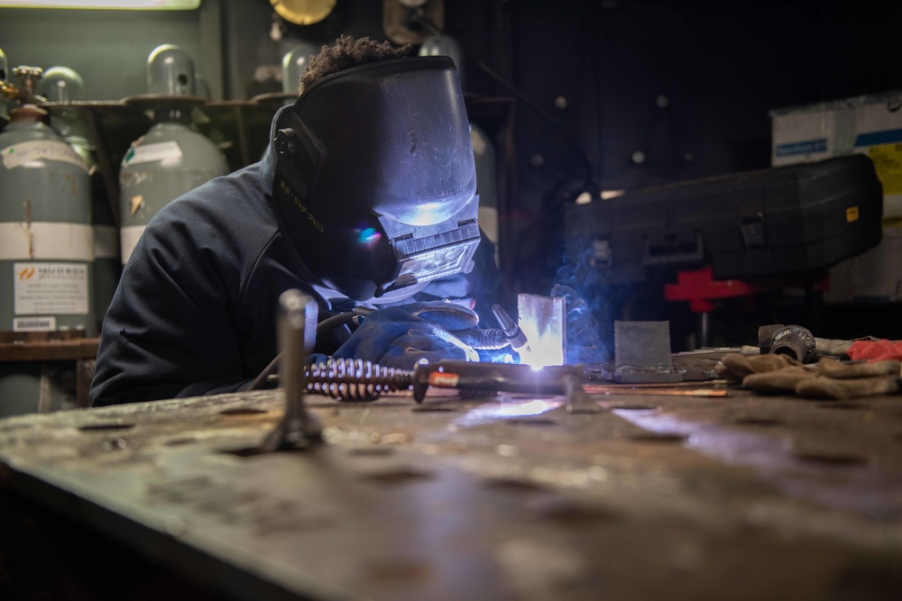 Navy Hull Maintenance Technician welds