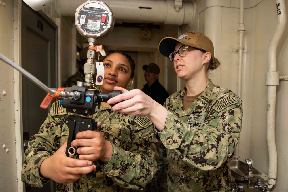 U.S. Sailors claibrate a pressure switch
