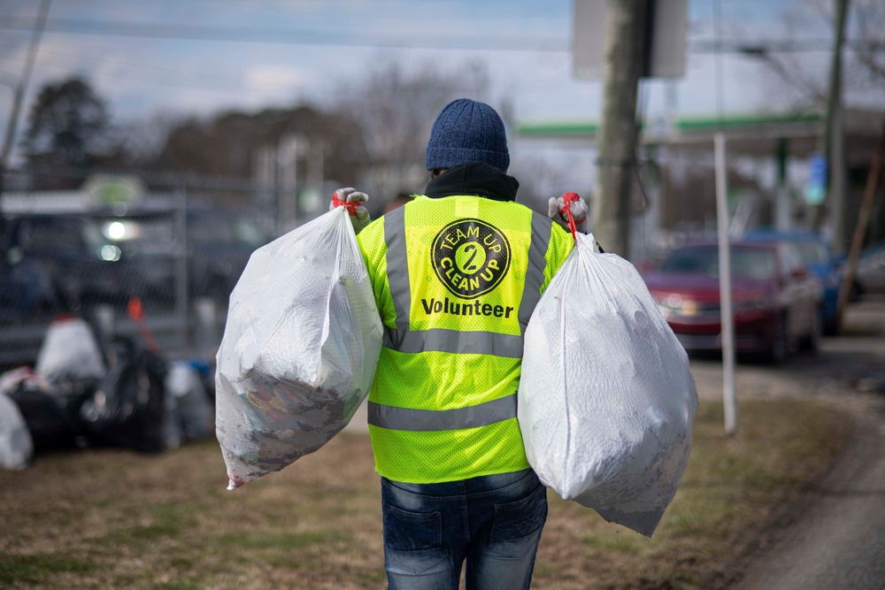 U.S. Navy Aviation Support Equipment Technician 3rd Class Aaron Sanders, from Philadelphia, carries trash bags after picking up litter in Norfolk, Virginia, Feb. 29, 2020.