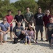 Members of the U.S. military community work with Henoko Senior Citizen’s Association members cleaning up