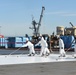U.S. Navy civilian personnel paint the flight deck