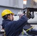 Sailor attaches lanyard around a hook