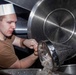 Sailor pours shrimp into a pan