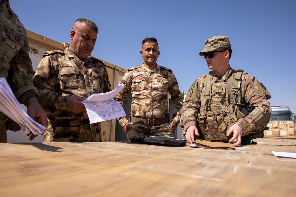 Coalition Forces transfer arms, equipment, vehicles to Iraqi forces