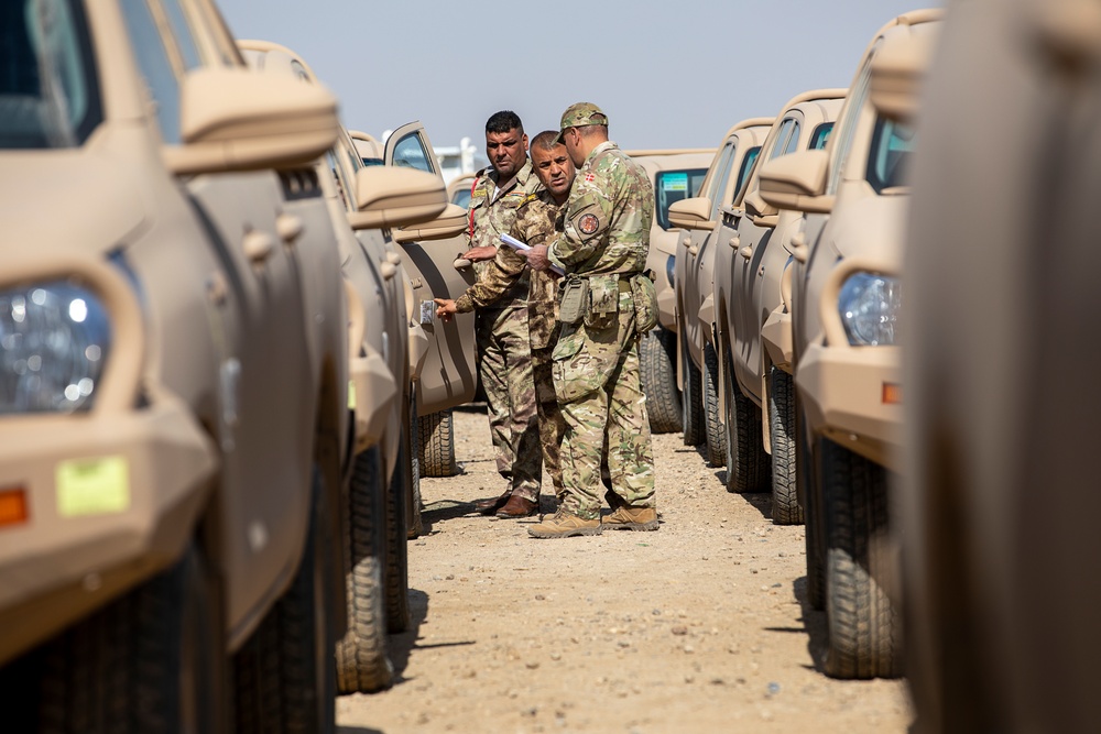 Coalition Forces transfer arms, equipment, vehicles to Iraqi forces