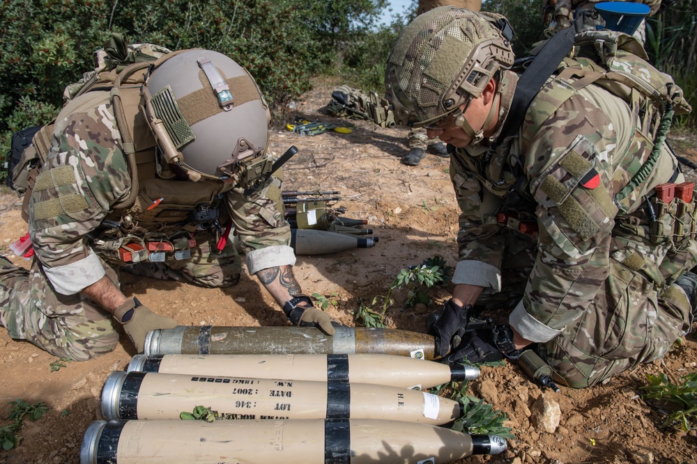 Explosive ordnance technicians conduct a simulated demolition shot, as part of surface cache prosecution training