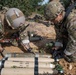 Explosive ordnance technicians conduct a simulated demolition shot, as part of surface cache prosecution training