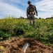 Explosive ordnance technicians conduct a close-range recon of a buried unexploded ordnance (UXO), as part of EOD surface response training