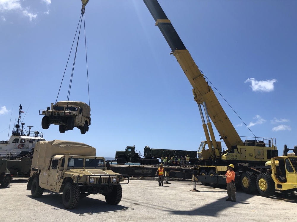 U.S. Navy Seabees with NMCB-5’s Detail Tinian embark to the island