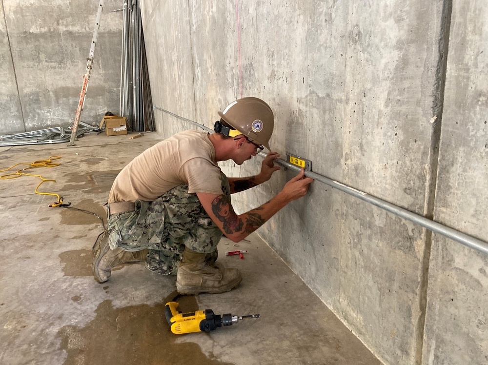 U.S. Navy Seabees with NMCB-5’s Detail Tinian Construct Explosive Ordnance Disposal Mobile Unit 5’s Boat Storage Facility