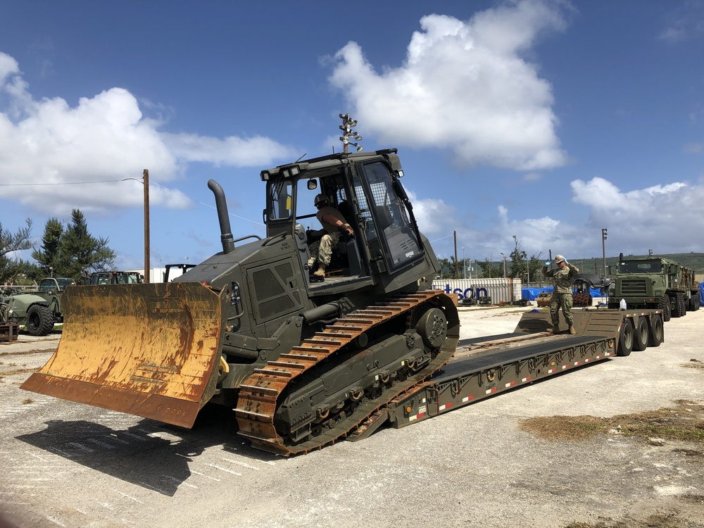 U.S. Navy Seabees with NMCB-5’s Detail Tinian embark to the island