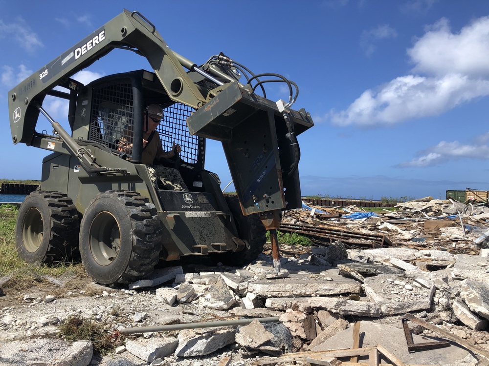 U.S. Navy Seabees with NMCB-5’s Detail Tinian embark to the island