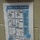 A hand-washing instructional poster titled 'Clean Your Hands!' is affixed to a beige/tan textured wall. The poster displays step-by-step illustrated instructions for both soap-and-water handwashing and alcohol-based hand sanitizer use. It appears to be an official public health poster from the Minnesota Department of Health (MDH).