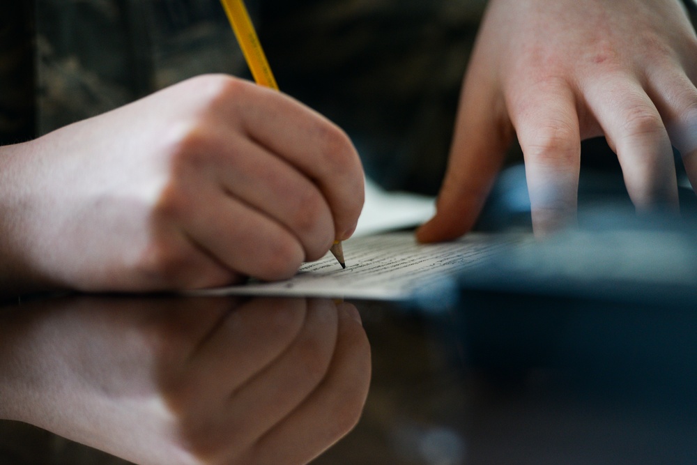 Staff Sgt. James Miller makes corrections to a story