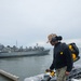 U.S. Sailor blows debris off the flight deck