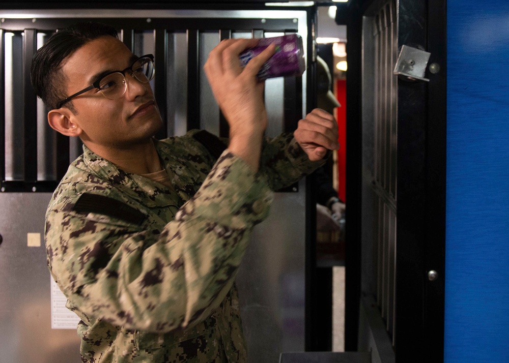 U.S. Sailor stockes a vending machine