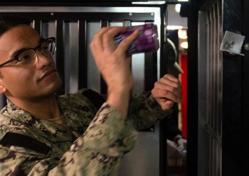 U.S. Sailor stockes a vending machine