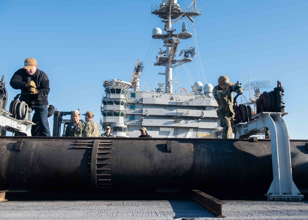 U.S. Sailors raise catapult
