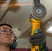 Sailors make repairs to a gym