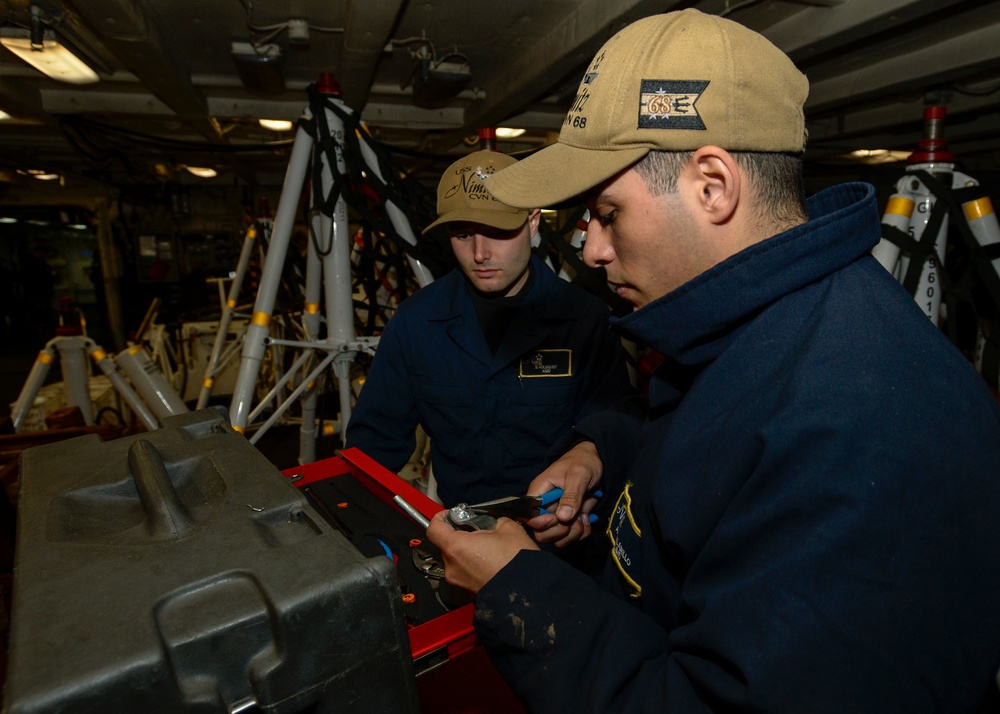 Nimitz Sailors Use Pliers During Aircraft Jack Maintenance