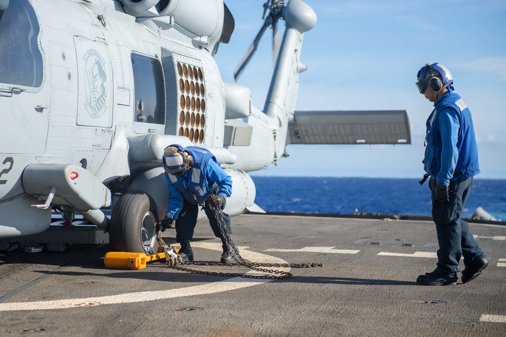 Sailors Remove Chock and Chains From MH-60R Sea Hawk