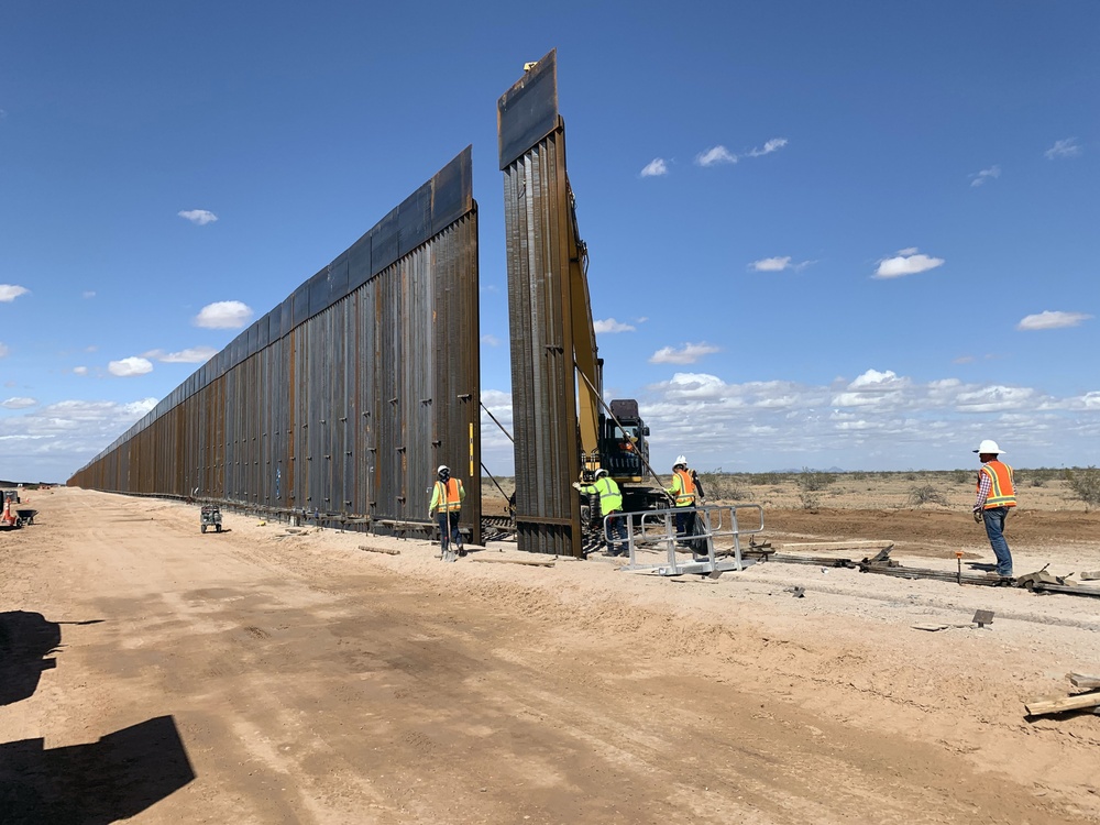 Crews install a three-ton, 30-foot barrier panel at the Barry M. Goldwater Range