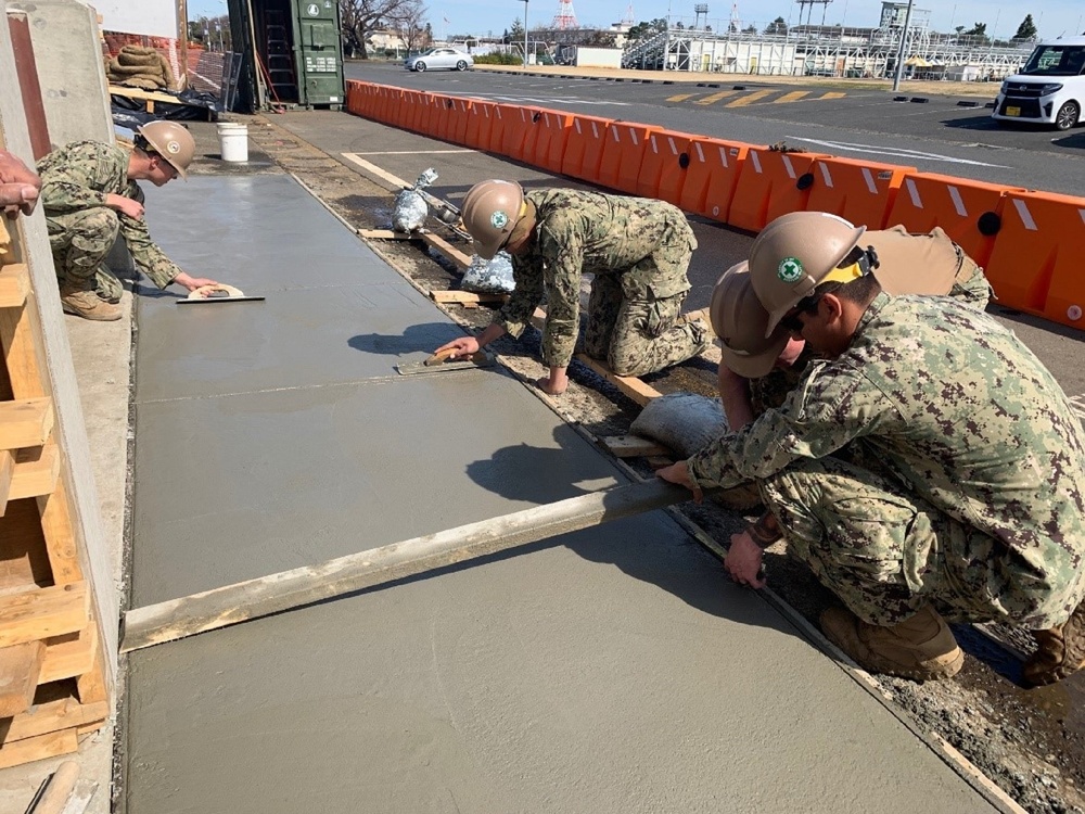 U.S. Navy Seabees with NMCB-5's Detail Atsugi construct a loading dock for the Navy Exchange