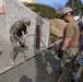 U.S. Navy Seabees with NMCB-5's Detail Atsugi construct a loading dock for the Navy Exchange