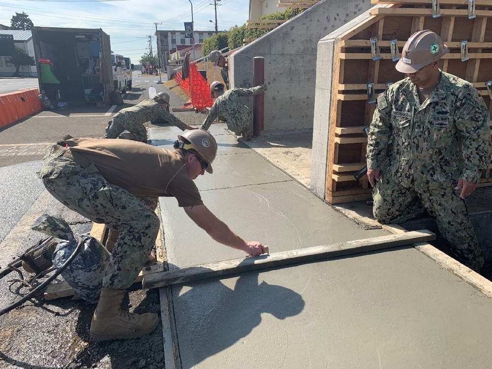 U.S. Navy Seabees with NMCB-5's Detail Atsugi construct a loading dock for the Navy Exchange
