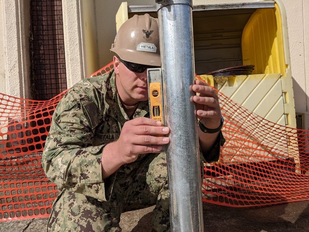 U.S. Navy Seabees with NMCB-5's Detail Atsugi construct a loading dock for the Navy Exchange