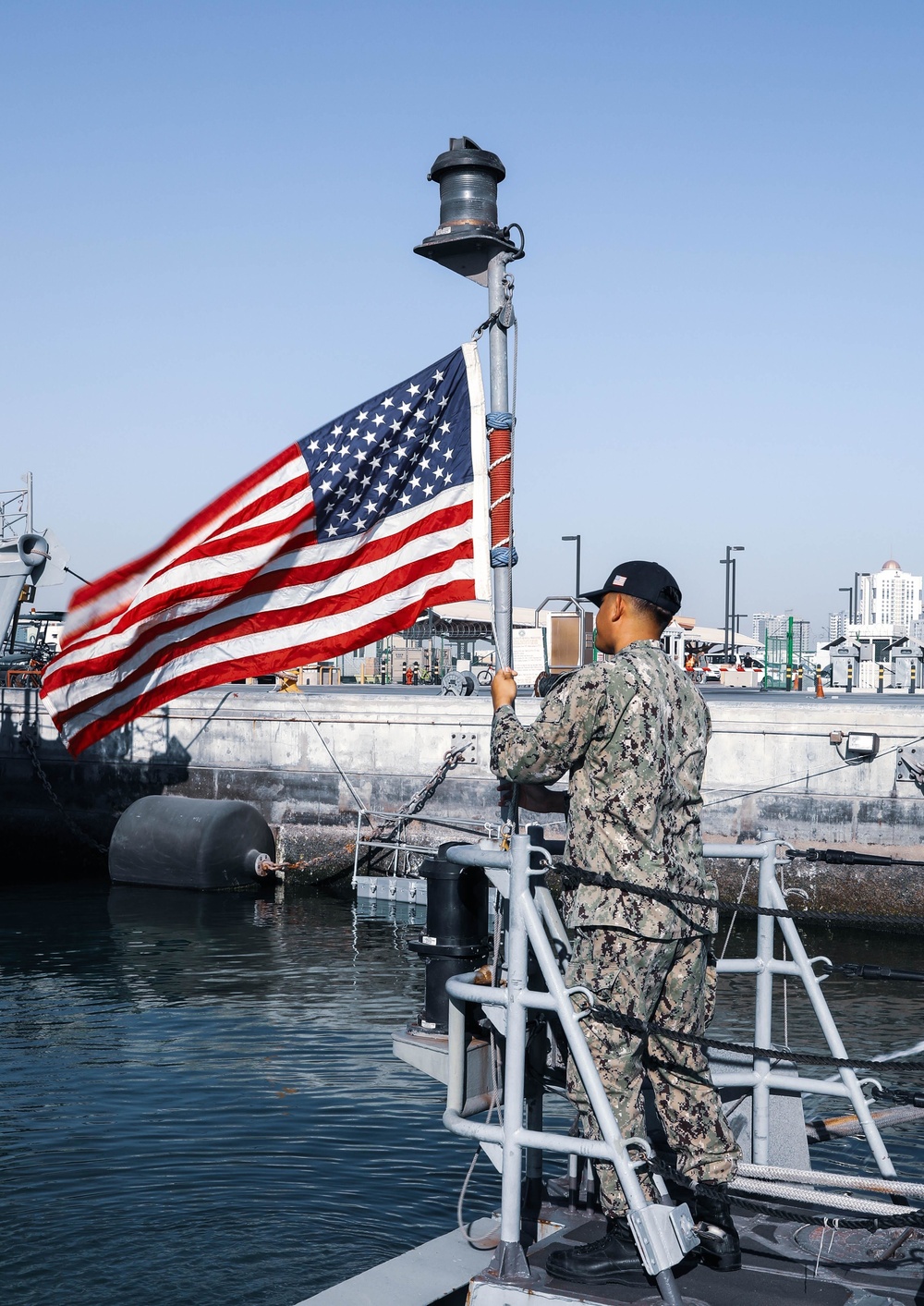 Hospital Corpsman 1st Class Christian Gueuara hoists the American flag