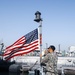 Hospital Corpsman 1st Class Christian Gueuara hoists the American flag