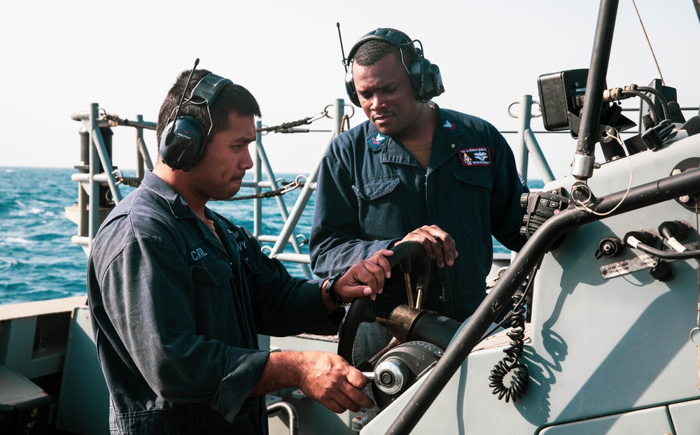 Engineman 2nd Class Ianjames Castil and Machinist’s Mate 2nd Class Brian Whittington Jr. conduct a boat report