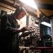 Engineman 2nd Class Ianjames Castil inspects an engine