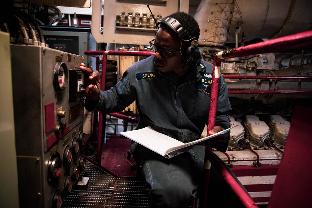 Chief Engineman Josaphat Satenay inspects an engine