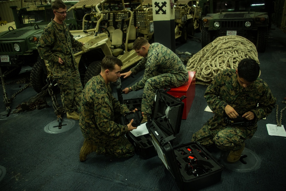 Marines with the 31st MEU conduct function checks on their Instant Eye drone system