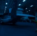 Sailors move aircraft at night.
